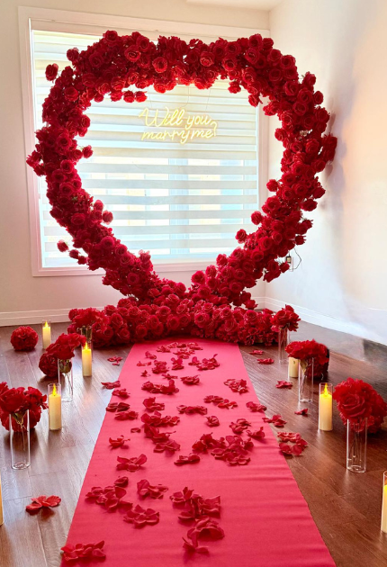 Romantic red heart-shaped flower wall for wedding proposals and photo moments