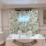 Luxurious white 5D floral wall with layered silk flowers and three-dimensional texture, perfect for weddings and high-end events.