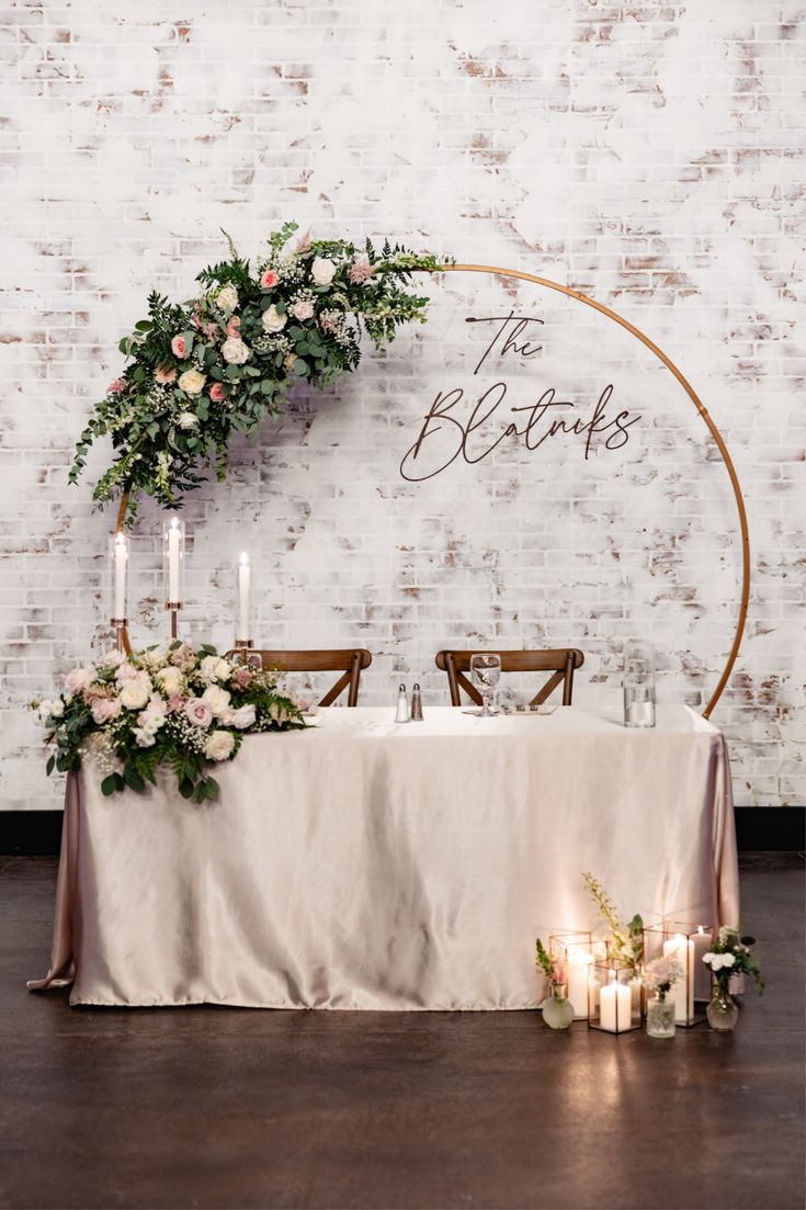 Round arch head table adorned with cherry blossom floral decor