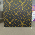 High-quality decorative photo booth backdrop with professional event lighting.