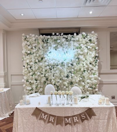 Luxurious white 5D floral wall with layered silk flowers and three-dimensional texture, perfect for weddings and high-end events.
